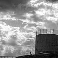 Concrete dam spillway with stormy skies